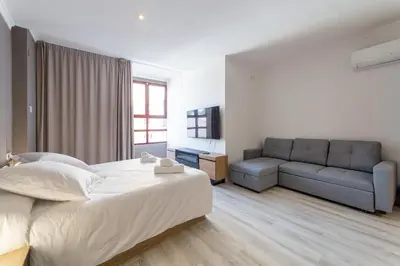 a bedroom with a large bed and a couch at Albufera Dreams Nature Suites in Valencia