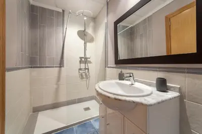 a bathroom with a sink and a mirror and a tub at Albufera Dreams Nature Suites in Valencia