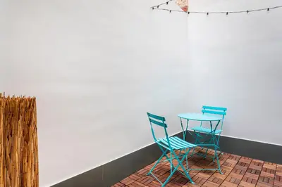 two blue chairs and a table in a room at Apartamento B Cube by Mimood Aparthotels in Valencia