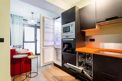 a kitchen with a stove and a microwave at Apartamento B Cube by Mimood Aparthotels in Valencia