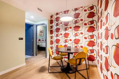 a dining room with a table and yellow chairs at Apartamento B Cube by Mimood Aparthotels in Valencia