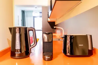 two coffeemakers sitting on a wooden counter at Apartamento B Cube by Mimood Aparthotels in Valencia