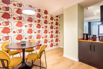a dining room with a table and yellow chairs at Apartamento B Cube by Mimood Aparthotels in Valencia