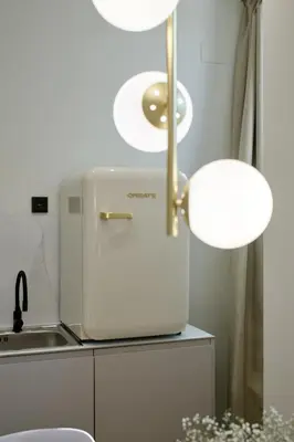 a white refrigerator in a kitchen with a lamp at Romantic Apartment N1 Oceanografico Virkin Suites in Valencia