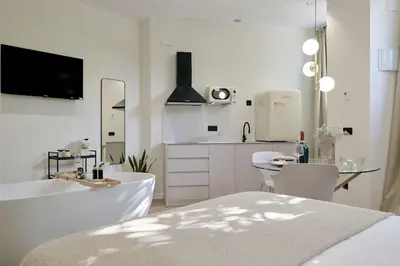 a white kitchen with a tub and a sink at Romantic Apartment N1 Oceanografico Virkin Suites in Valencia