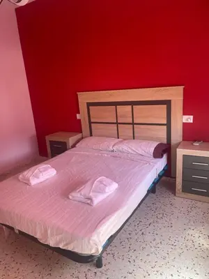 a bedroom with a bed with two towels on it at Casa JUANES in Cullera