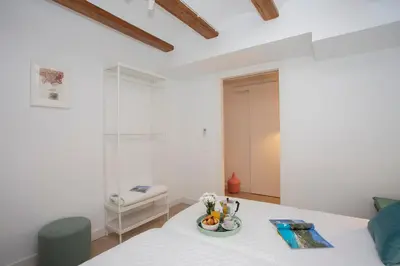 a white room with a table with a plate of flowers at SingularStays Casa del Grao in Valencia