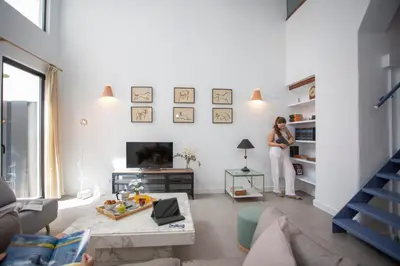 a woman is standing in a living room at SingularStays Casa del Grao in Valencia