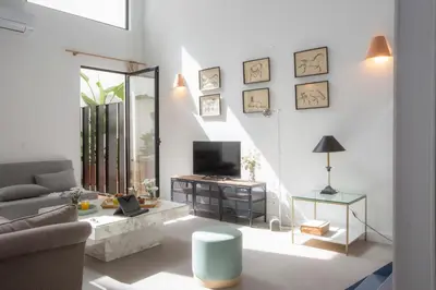 a living room with a couch and a tv at SingularStays Casa del Grao in Valencia