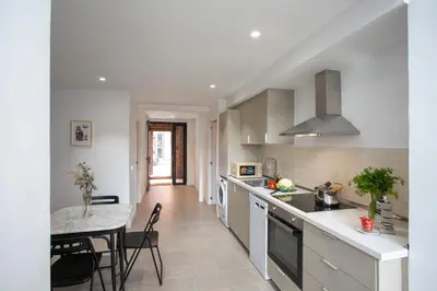 a kitchen with a table and a dining room at SingularStays Casa del Grao in Valencia