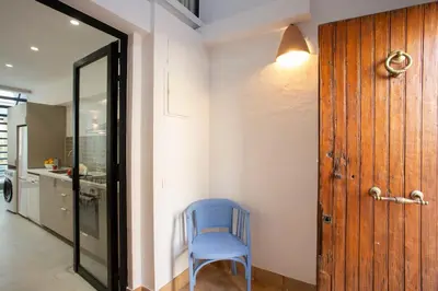 a blue chair sitting in a hallway next to a door at SingularStays Casa del Grao in Valencia