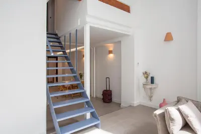a blue staircase in a room with a couch at SingularStays Casa del Grao in Valencia