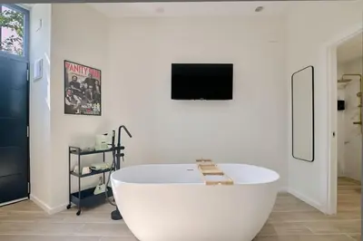 a white bath tub in a room with a tv at Romantic Apartment N2 Oceanografico Virkin Suites in Valencia