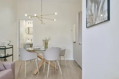 a dining room with a table and white chairs at Romantic Apartment N3 Oceanografico Virkin Suites in Valencia