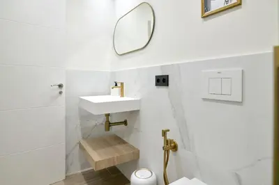 a white bathroom with a sink and a mirror at Romantic Apartment N3 Oceanografico Virkin Suites in Valencia