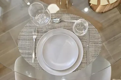 a table with a plate and glasses on a table at Romantic Apartment N3 Oceanografico Virkin Suites in Valencia