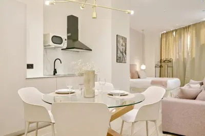 a white living room with a table and chairs at Romantic Apartment N3 Oceanografico Virkin Suites in Valencia