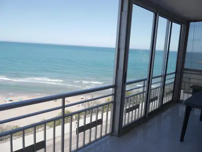a view of the beach from the balcony of a condo at HAWAI, Esc-3, 3-16 in Faro de Cullera