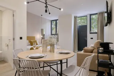 a dining room and living room with a table and chairs at Romantic Apartment N5 Oceanografico Virkin Suites in Valencia