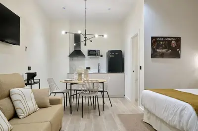 a living room with a bed and a table in a room at Romantic Apartment N5 Oceanografico Virkin Suites in Valencia