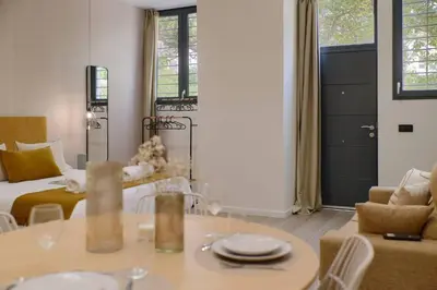 a living room with a bed and a table and chairs at Romantic Apartment N5 Oceanografico Virkin Suites in Valencia