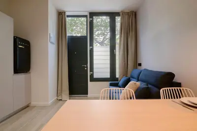 a living room with a blue couch and chairs at Romantic Apartment N6 Oceanografico Virkin Suites in Valencia