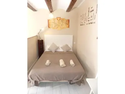 a bedroom with a bed with white shoes on it at Loft bajo vivienda centro de Valencia-Carmen in Valencia