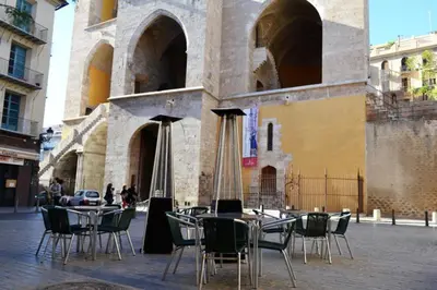 a group of tables and chairs in front of a building at Loft bajo vivienda centro de Valencia-Carmen in Valencia
