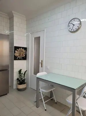a room with a table and a clock on the wall at Bella Morvedre in Sagunto