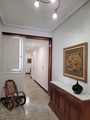 a room with a painting on the wall and a chair at Bella Morvedre in Sagunto