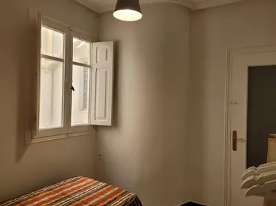 a room with a window and a bed and a door at Bella Morvedre in Sagunto