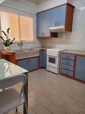 a kitchen with blue cabinets and a white oven at Bella Morvedre in Sagunto
