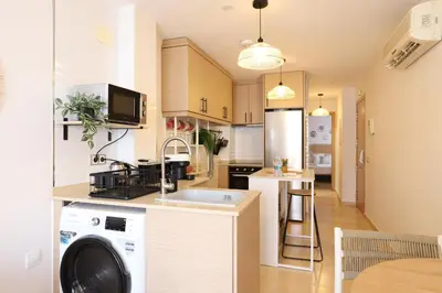 a kitchen with a washer and a dishwasher in it at Tranquilo y delicioso rincón junto al mar in Puerto de Sagunto