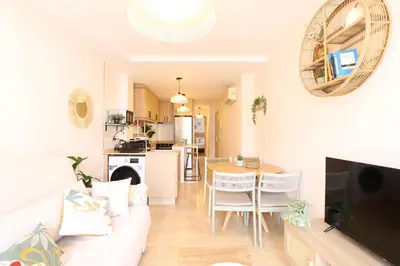 a living room with a white couch and a table at Tranquilo y delicioso rincón junto al mar in Puerto de Sagunto