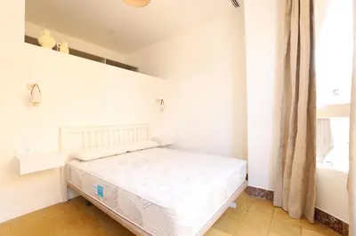 a white bedroom with a bed in a room at Tradición y modernidad Casa de pueblo junto al mar in Puerto de Sagunto