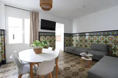 a living room with a table and a couch at Tradición y modernidad Casa de pueblo junto al mar in Puerto de Sagunto