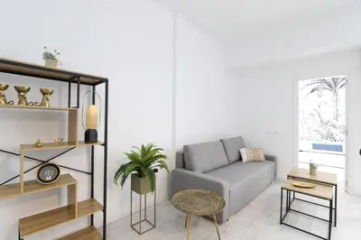 a living room with a couch and a table at Deslumbrante y familiar casa cerca de la playa in Puerto de Sagunto