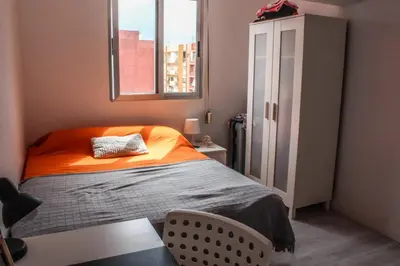 a small bedroom with a bed and a window at Flat close to beach perfect for families and groups - Actor Mauri 18 in Valencia