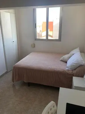 a small bedroom with a bed and a window at Flat close to beach perfect for families and groups - Actor Mauri 18 in Valencia