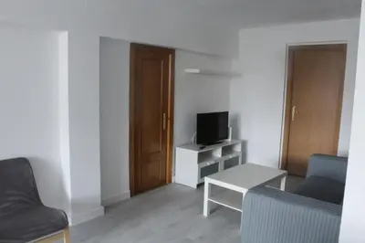 a living room with a couch and a television at Flat close to beach perfect for families and groups - Actor Mauri 18 in Valencia