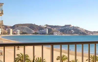 a swimming pool with a slide in front of a building at Apartamento Premium frente al mar, en primera linea de playa in Cullera