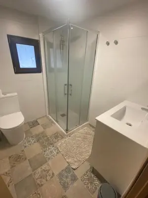 a bathroom with a shower and a toilet and a sink at Rey Elzinga in Godelleta