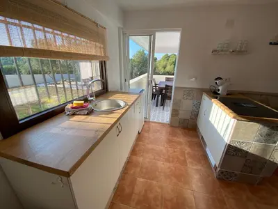 a kitchen with a sink and a large window at Rey Elzinga in Godelleta