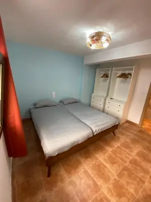 a bedroom with a bed and a chandelier at Rey Elzinga in Godelleta