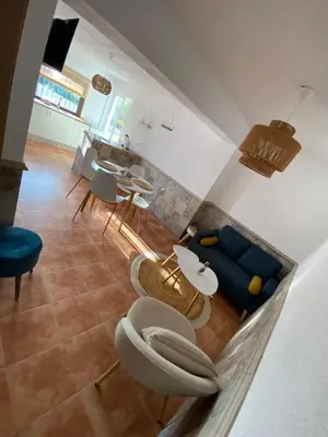 a living room with a blue couch and a table at Rey Elzinga in Godelleta