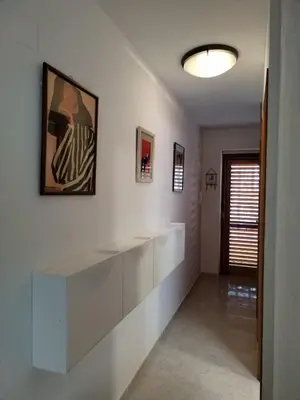 a white room with a large white shelf on the wall at Ático Playa Cullera in Cullera