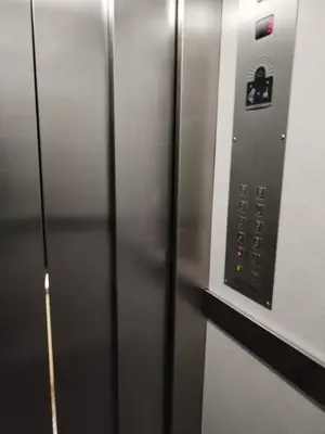 an elevator door with a sign on it at Ático Playa Cullera in Cullera