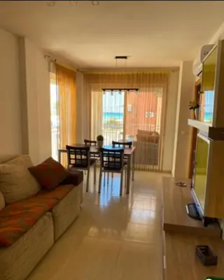 a living room with a couch and a table at Magnífico piso con vistas al mar en Moncofa in Moncófar