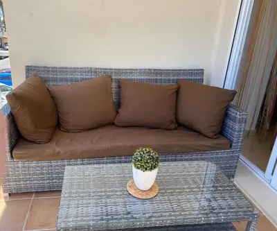 a couch with a table and a potted plant on it at Magnífico piso con vistas al mar en Moncofa in Moncófar