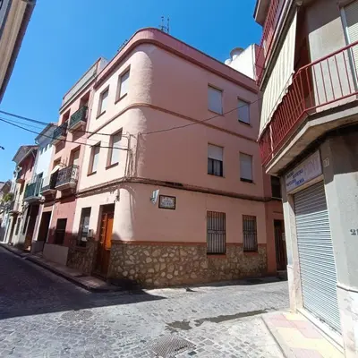 a pink building on the side of a street at Casa Central in Cullera